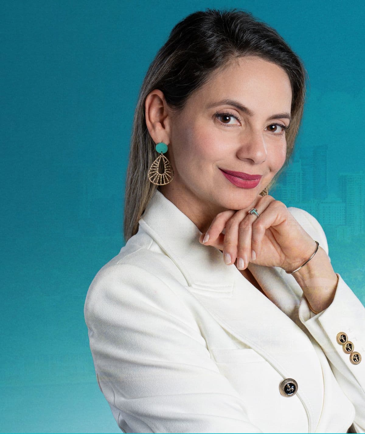 Lorena Cabal, real estate agent, in a white blazer against a turquoise backdrop